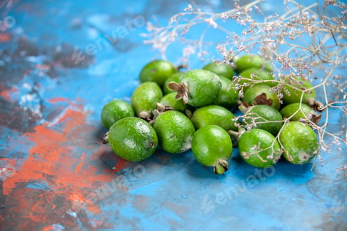 Preview: Front close view of fresh natural delicious green feijoas on blue background