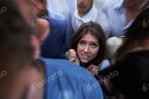 Preview: Drowning in people. Shot of a fearful young woman feeling trapped by the crowd.