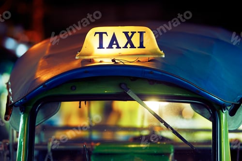Preview: Illuminated Taxi Top at Night in City