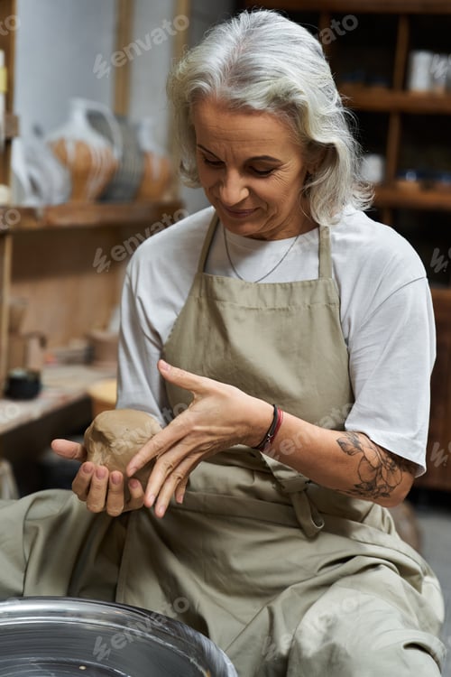 Preview: Creative artisan shaping clay into beautiful pottery in a cozy studio filled with inspiration