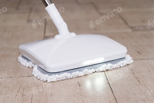 Preview: A man washes the floor in an apartment with a modern electric mop