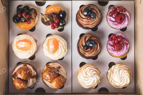 Preview: top view of sweet cupcakes in cardboard box