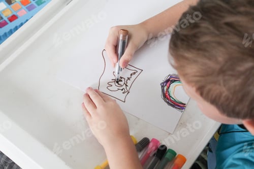 Preview: Child Draws Pictures at Home with Markers