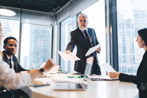 Preview: Group of diverse colleagues analyzing documents in office together