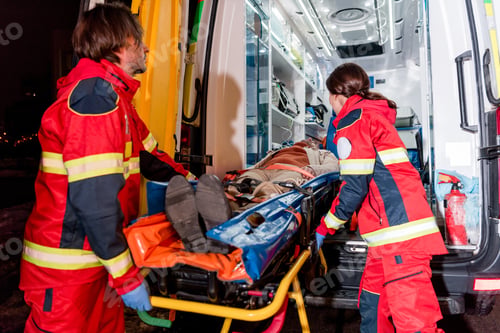 Preview: Paramedics transportating patient on gurney in ambulance car