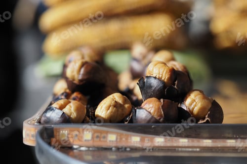 Preview: Roasted chestnuts served on a tray in a market