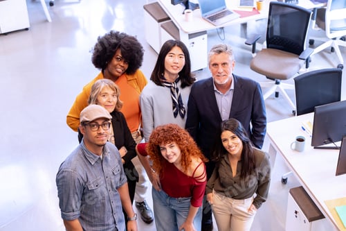 Preview: Diverse business team smiling while posing together in the office.