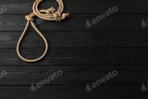 Preview: Lasso made of cotton rope on black wooden background, top view. Space for text