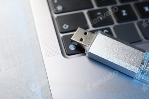 Preview: Flash drive and laptop on light grey table, closeup