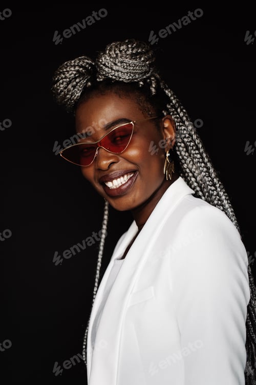 Preview: Young black woman wearing sunglasses and smiling