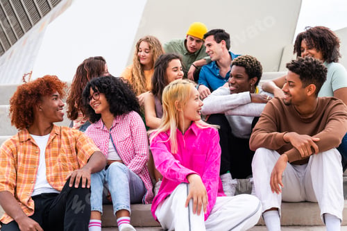 Preview: Happy playful multiethnic group of young friends bonding outdoors