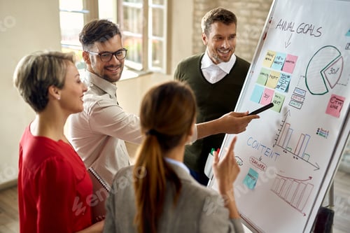 Preview: Group of happy entrepreneurs working on new business strategy in the office.
