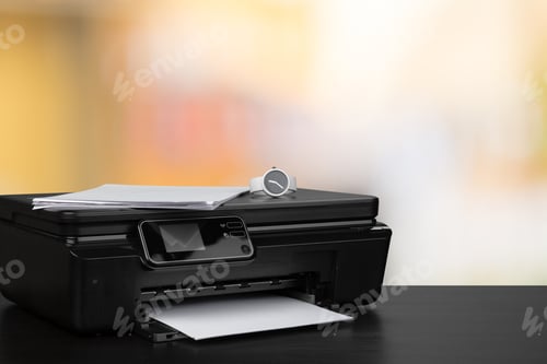 Preview: Compact laser printer on black desk against blurred background