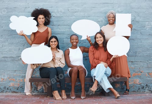 Preview: Group of five young happy cheerful businesswomen standing and sitting on a bench against a wall out
