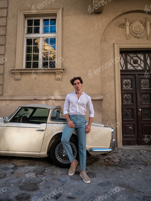 Preview: Attractive, Handsome Man Leaning On A Retro Car In A White Shirt.