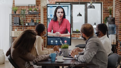 Preview: Colleagues meeting with woman on video call conference