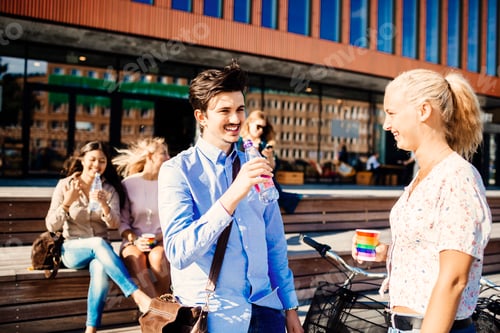Preview: Happy friends having refreshments outside concert hall