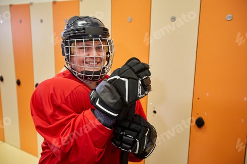 Preview: Smiling Hockey Player Posing in Locker Room