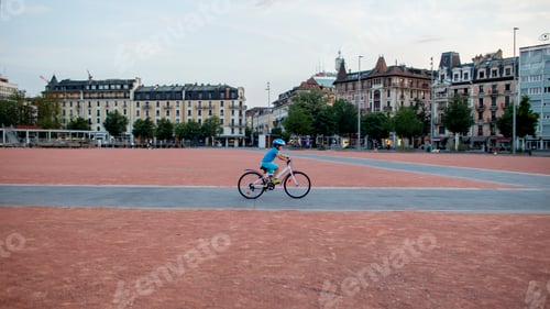 Preview: A cheerful child rides a bicycle through the city, wearing a helmet for safety