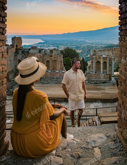 Preview: couple men and woman visit Ruins of Ancient Greek theatre in Taormina Sicily.