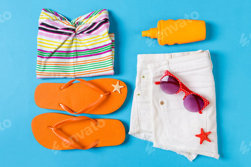 Preview: Flat lay composition with Beach accessories on blue color background. Summer
