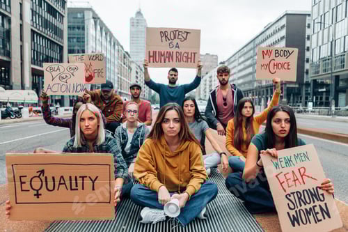 Preview: group of young people holding protest banners in a march for the woman rights and gender equality