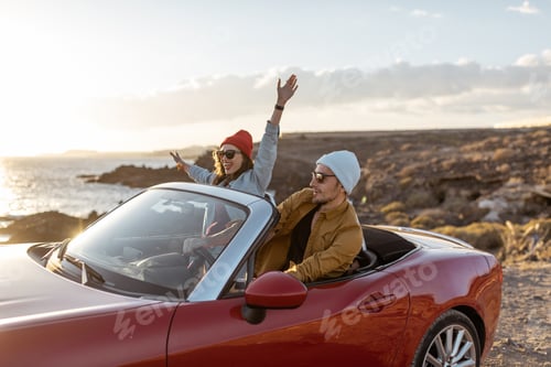 Preview: Lovely couple driving a cabriolet near the ocean