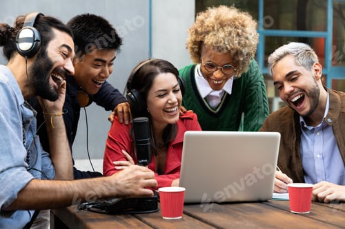 Preview: Multiracial influencers recording social media content outdoors. Using laptop,microphone headphones.