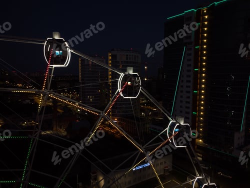 Preview: Beautiful sunset over the city with a lighted Ferris wheel.
