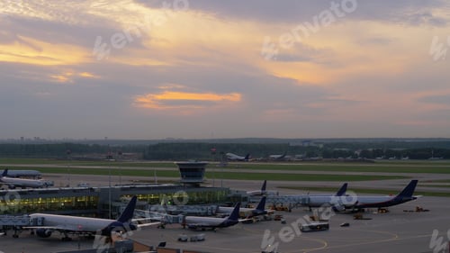Preview: Airport view with airplanes boarding and taking off