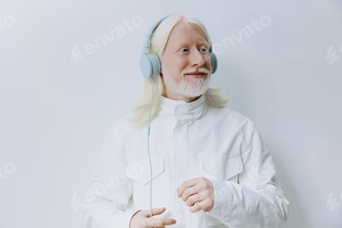 Preview: elderly man wearing headphones, listening to music, enjoying sound, modern lifestyle, white