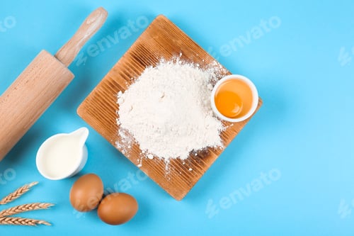 Preview: Flat lay composition with eggs and other ingredients on light blue background. Baking pie