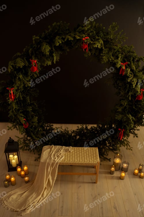Preview: Cozy holiday scene with a large wreath, candles, and a bench draped with a blanket on a wooden floor