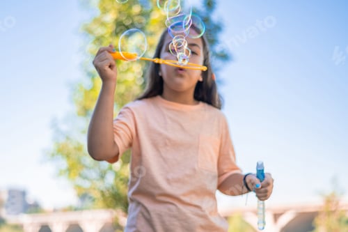 Preview: Child playing bubbles outdoors during a summer day
