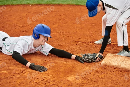 Preview: Two teenage boys engaged in a thrilling baseball play on a vibrant field
