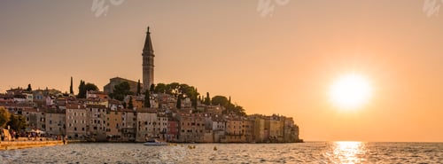 Preview: Golden sunset over the charming town of Rovinj, Croatia, casting reflections on tranquil waters