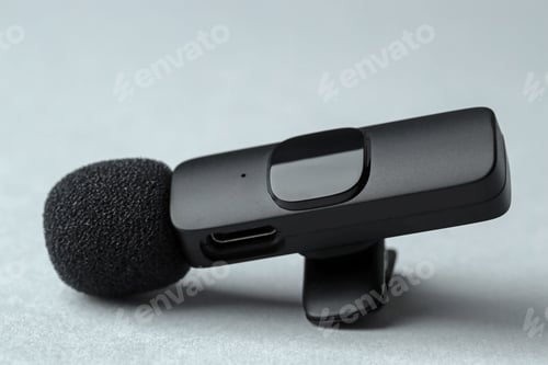Preview: Lavalier microphone on gray background, closeup. Audio equipment