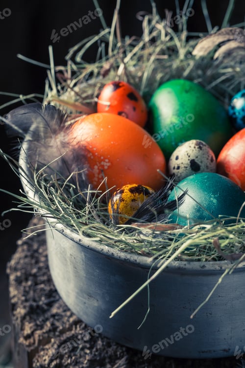 Preview: Closeup of colourfull eggs for Easter on hay