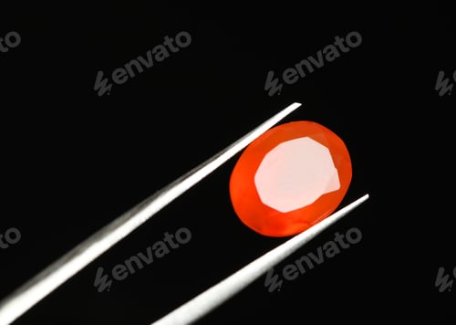 Preview: Tweezers with beautiful gemstone on black background. Space for text
