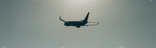 Preview: Silhouette of airplane in sky with sunlight, panoramic shot
