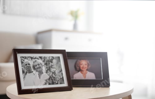 Preview: Portraits in stylish frames on table indoors