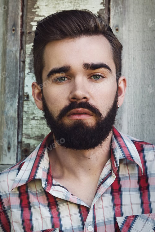 Preview: Handsome young bearded man in checkered shirt
