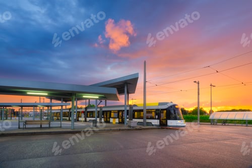 Preview: Tram stop. Public transport and sky during sunset. Architectural and infrastructural view.
