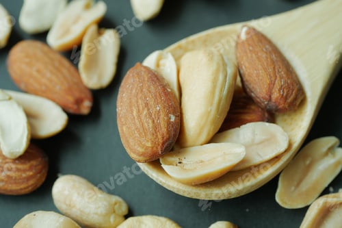 Preview: close up of almond nuts on a spoon on table