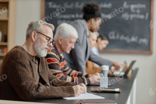 Preview: Middle Aged Caucasian Men Writing while Studying with Diverse Group in Classroom