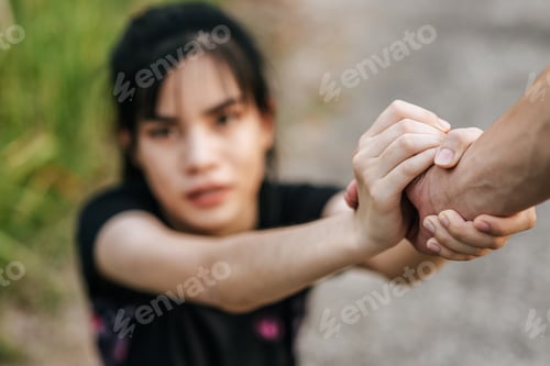 Preview: Women and men stand holding hands to exercise.
