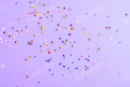 Preview: Colorful heart-shaped confetti scattered on purple background. Christmas or birthday concept