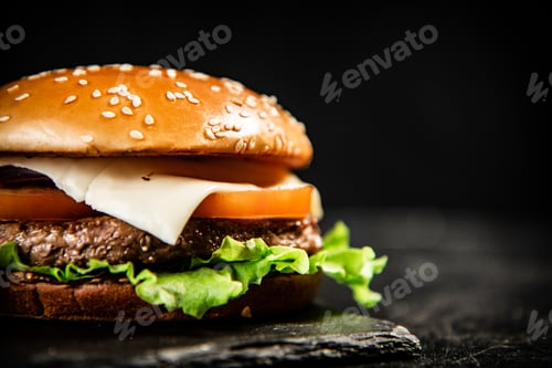 Preview: A burger on a stone board on a table.