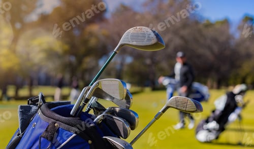 Preview: Closeup shot of golf clubs in a bag with a sportsman in the background