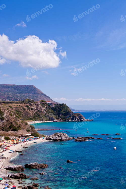 Preview: View of turquoise gulf bay, sandy beach, green mountains and plants, blue sky white clouds